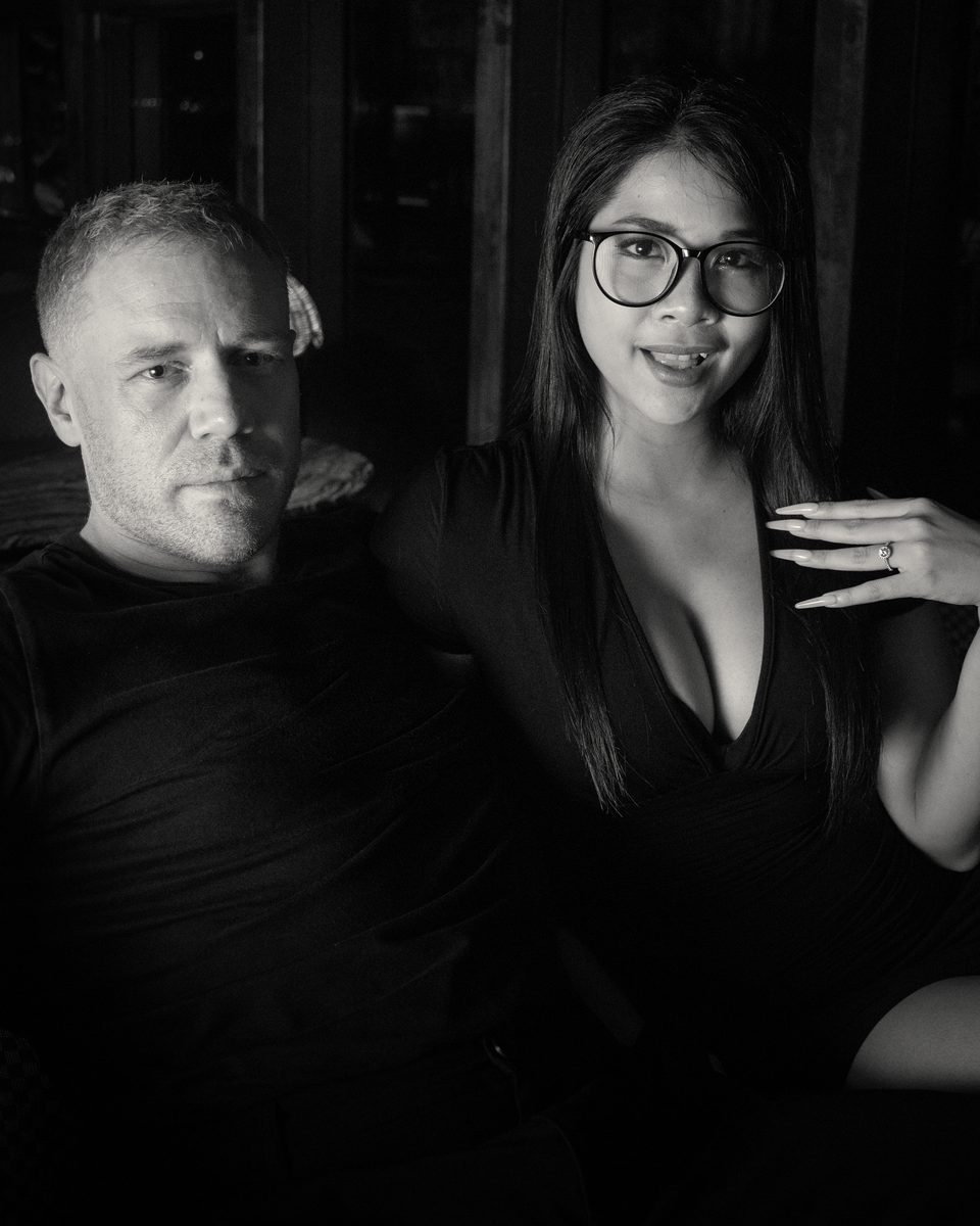 Tim and Paemi seated together in a lamp-lit lounge in Pattaya