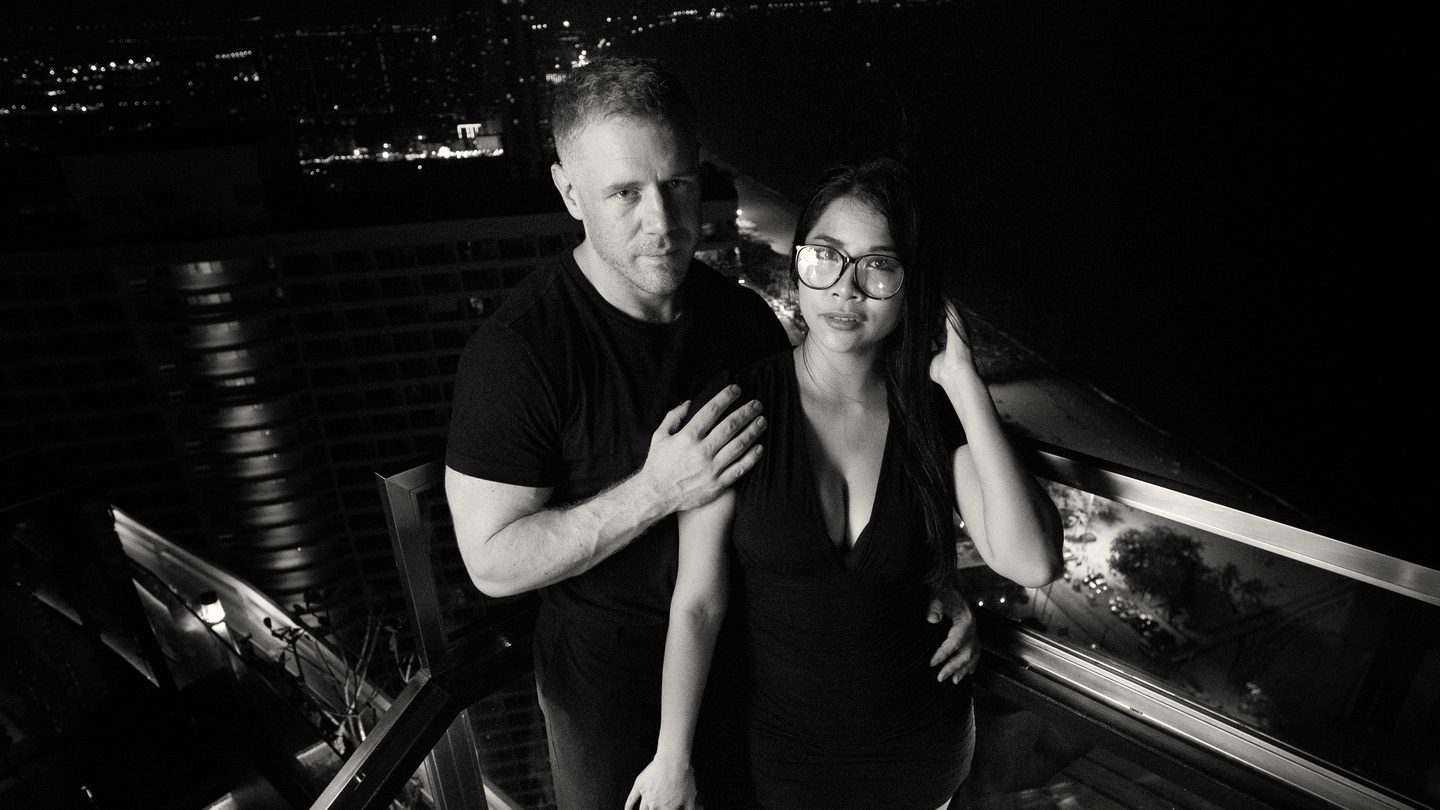 Tim and Paemi on a rooftop terrace above Pattaya at night
